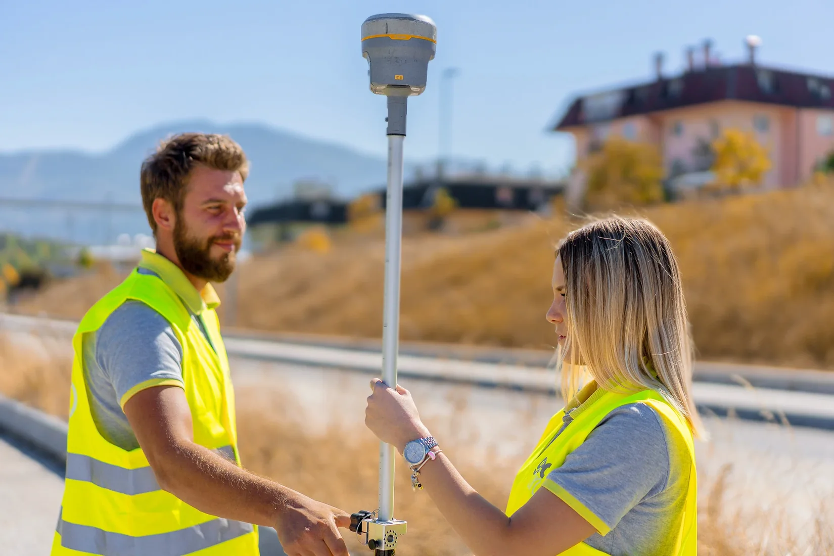 Geobiro surveyors working with a GNSS receiver on site.