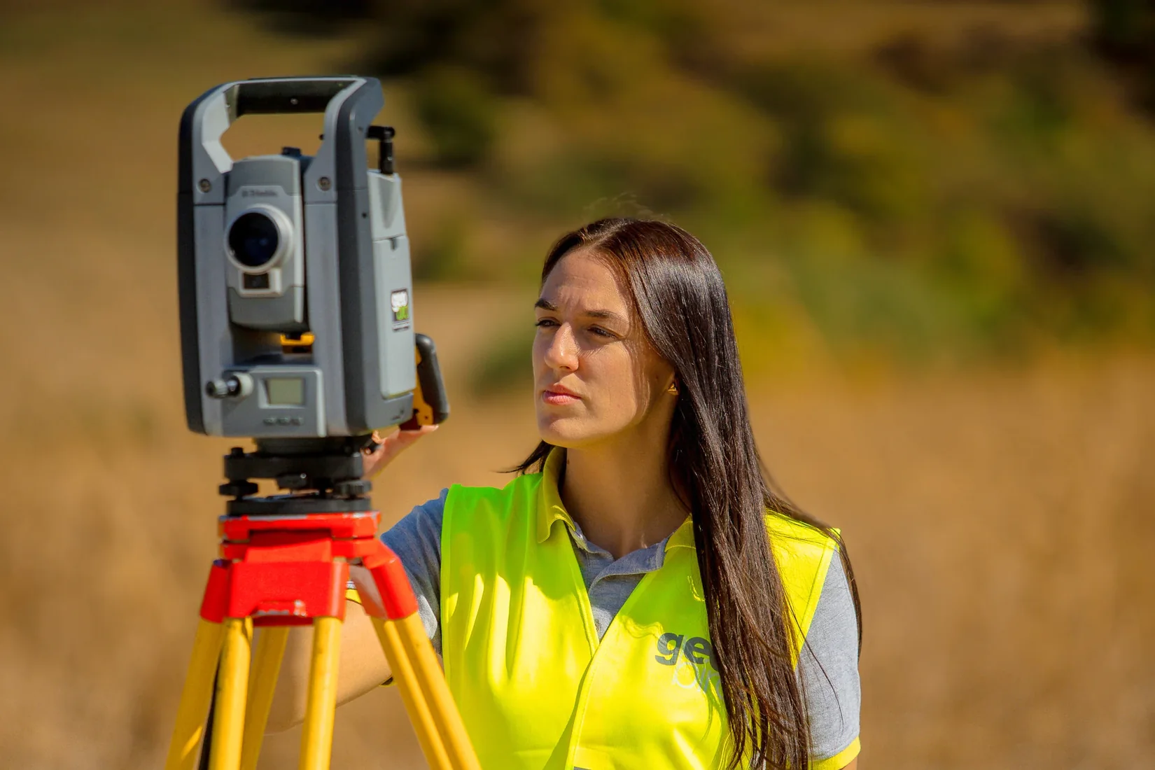 Geobiro surveyor using a tripod-mounted survey instrument.
