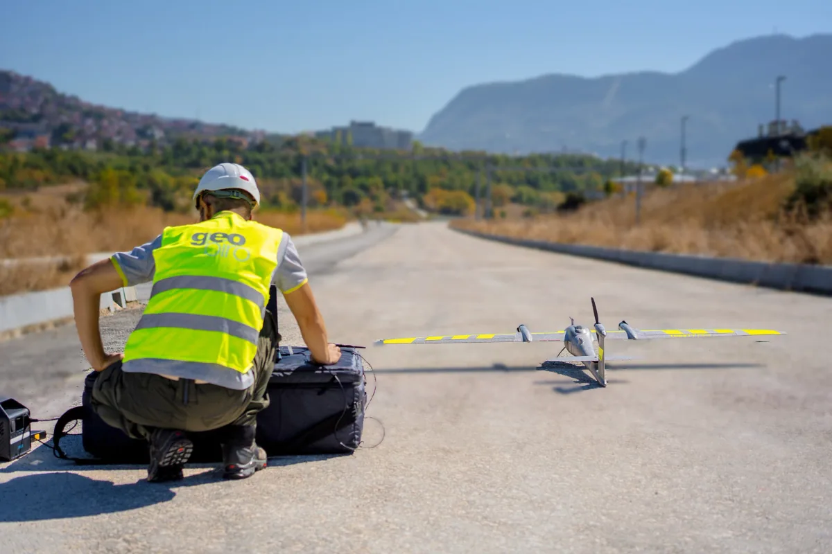 Geobiro operator preparing a fixed-wing surveying drone on site